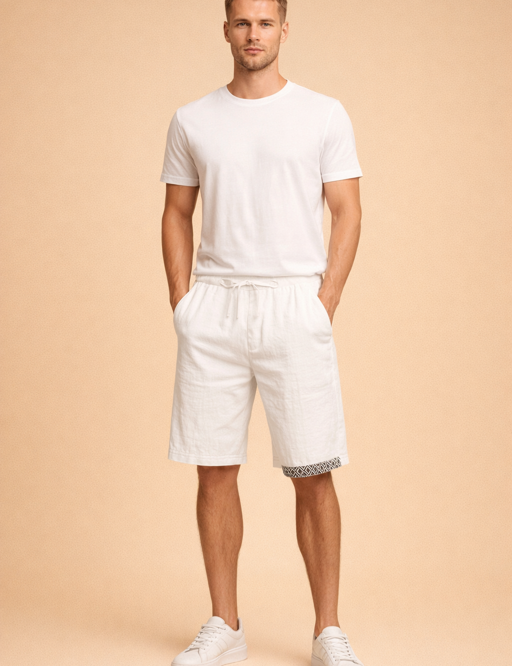 Men’s white lightweight linen shorts with adjustable drawstring waist and black geometric hem detail, styled with a clean white short sleeve crew neck T shirt and minimalist white low top sneakers for a refined summer casual look