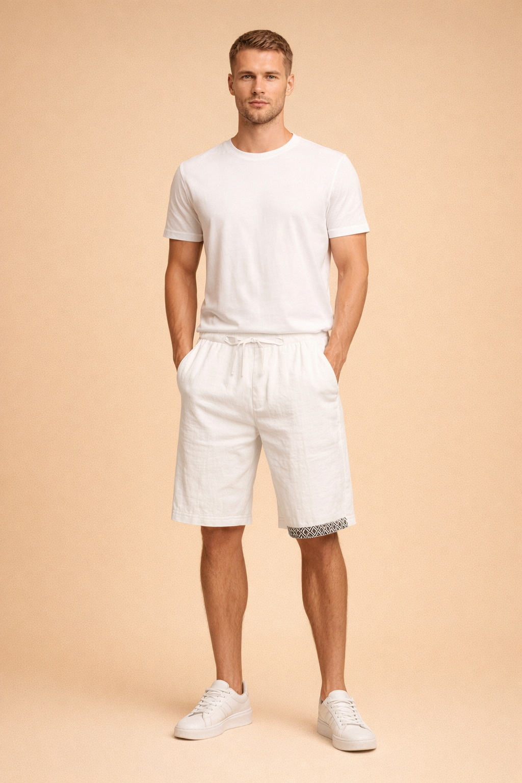 Men’s white lightweight linen shorts with adjustable drawstring waist and black geometric hem detail, styled with a clean white short sleeve crew neck T shirt and minimalist white low top sneakers for a refined summer casual look