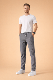 Men’s minimalist white short-sleeve t-shirt paired with straight-leg gray drawstring pants and clean white low-top sneakers, styled for a modern casual everyday look.