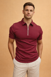 Men’s fitted short-sleeve zip-neck polo top paired with tailored light beige trousers, clean modern silhouette with a structured collar and smooth finish.