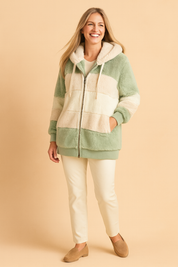 Cozy mint green and cream striped sherpa zip-up hoodie with ribbed cuffs, large hood, and drawstrings, paired with ivory straight-leg pants and tan suede loafers.