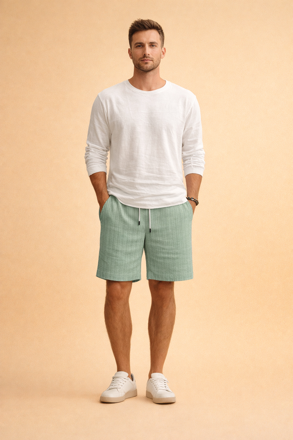 Mint green ribbed drawstring summer shorts paired with a clean white long-sleeve casual top and minimalist white low-profile sneakers, creating a relaxed yet refined warm-weather outfit with a lightweight textured finish and balanced proportions.
