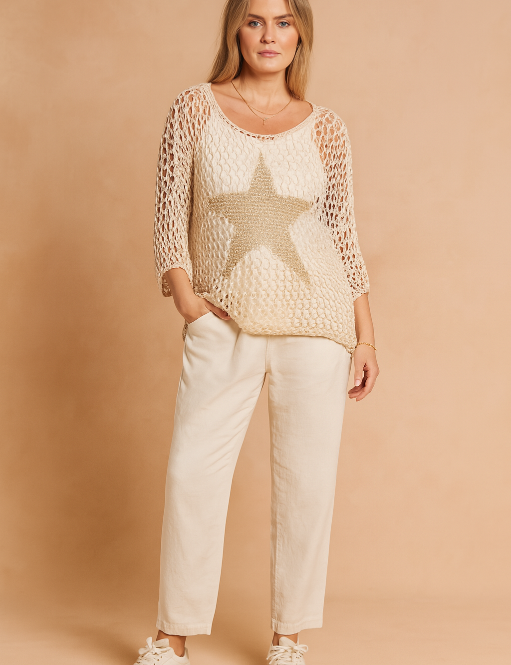 Beige open-knit sweater with metallic star design, styled with loose ivory trousers and cream sneakers for a relaxed yet chic look.