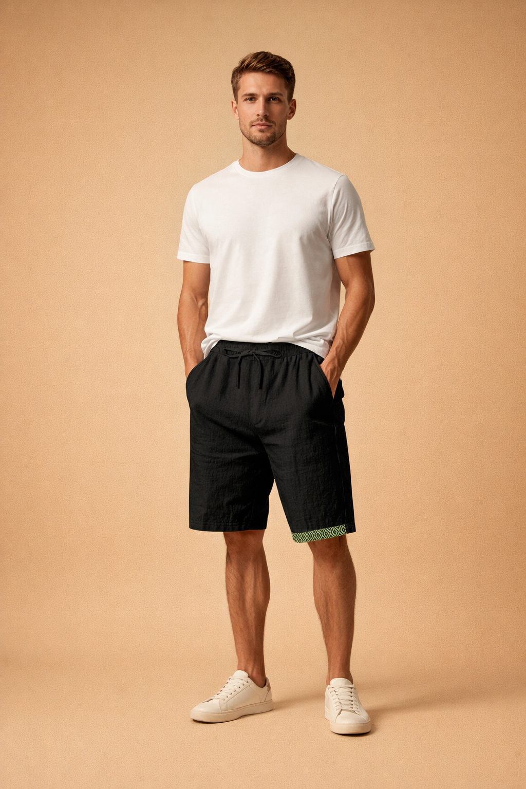 Minimalist white short-sleeve T-shirt paired with black relaxed-fit shorts featuring a subtle green geometric trim at the hem, styled with clean white low-top sneakers for a modern summer casual look