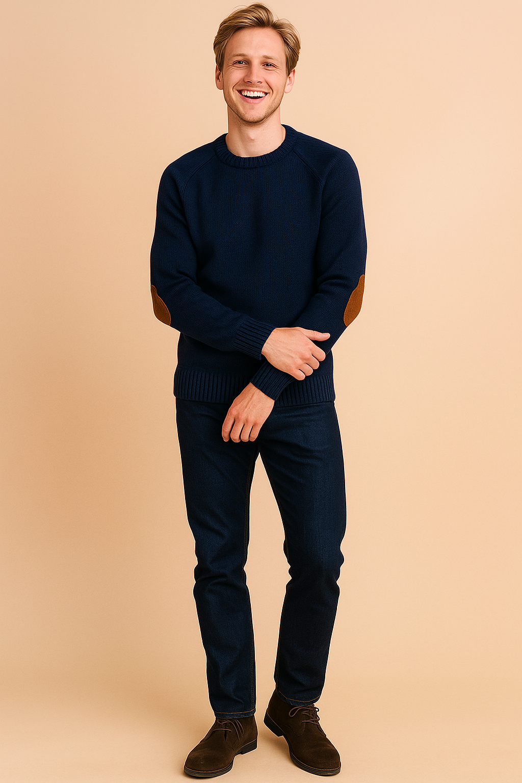 Navy blue crewneck sweater with ribbed cuffs and hem, featuring brown suede elbow patches, styled with dark blue jeans and brown suede lace-up boots.
