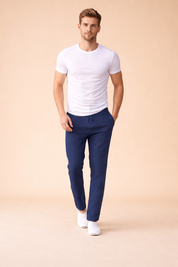 Navy blue tapered drawstring trousers styled with a fitted white short-sleeve T-shirt and clean white low-top sneakers for a modern casual look