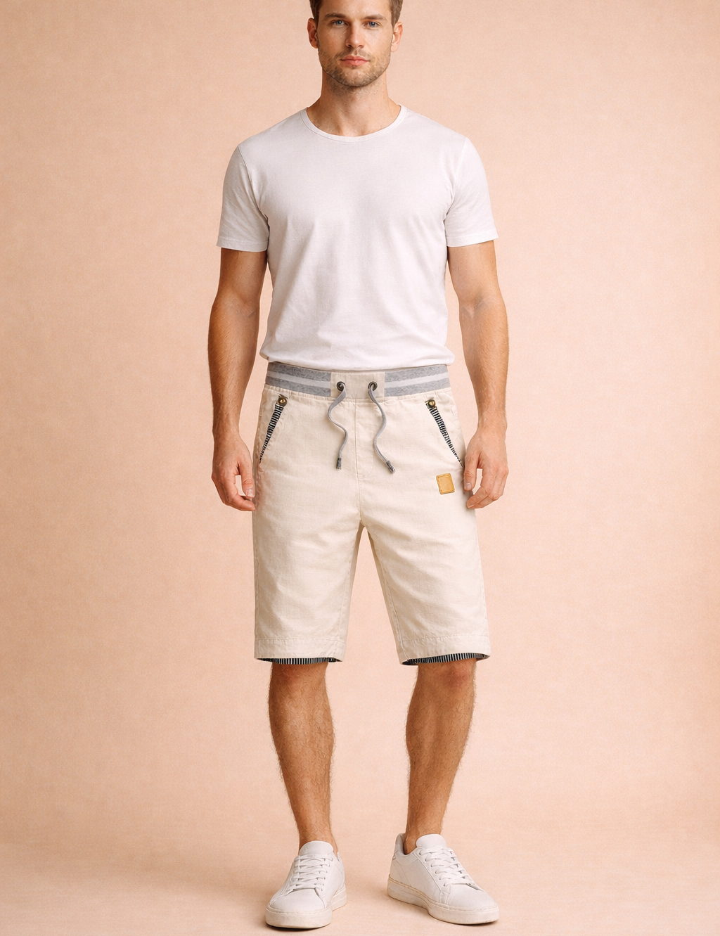 Off-white cotton drawstring shorts with grey ribbed waistband, striped pocket trim, tailored knee-length cut, paired with a clean white short-sleeve crew-neck T-shirt and minimalist white low-top sneakers