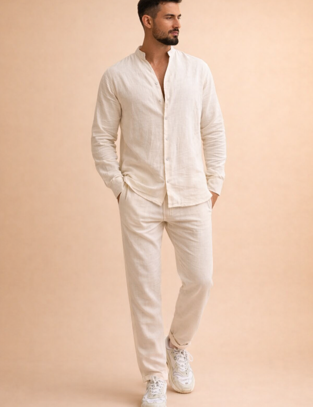 Off-white long-sleeve linen shirt with a relaxed band collar and front button placket, paired with matching off-white straight-leg linen trousers and clean white low-top sneakers