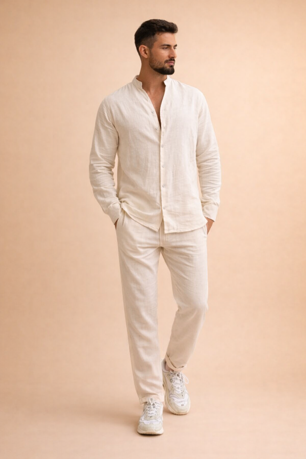 Off-white long-sleeve linen shirt with a relaxed band collar and front button placket, paired with matching off-white straight-leg linen trousers and clean white low-top sneakers