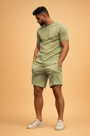 Olive green short sleeve fitted t-shirt paired with matching olive green tailored shorts in smooth cotton fabric with clean seams and minimal design