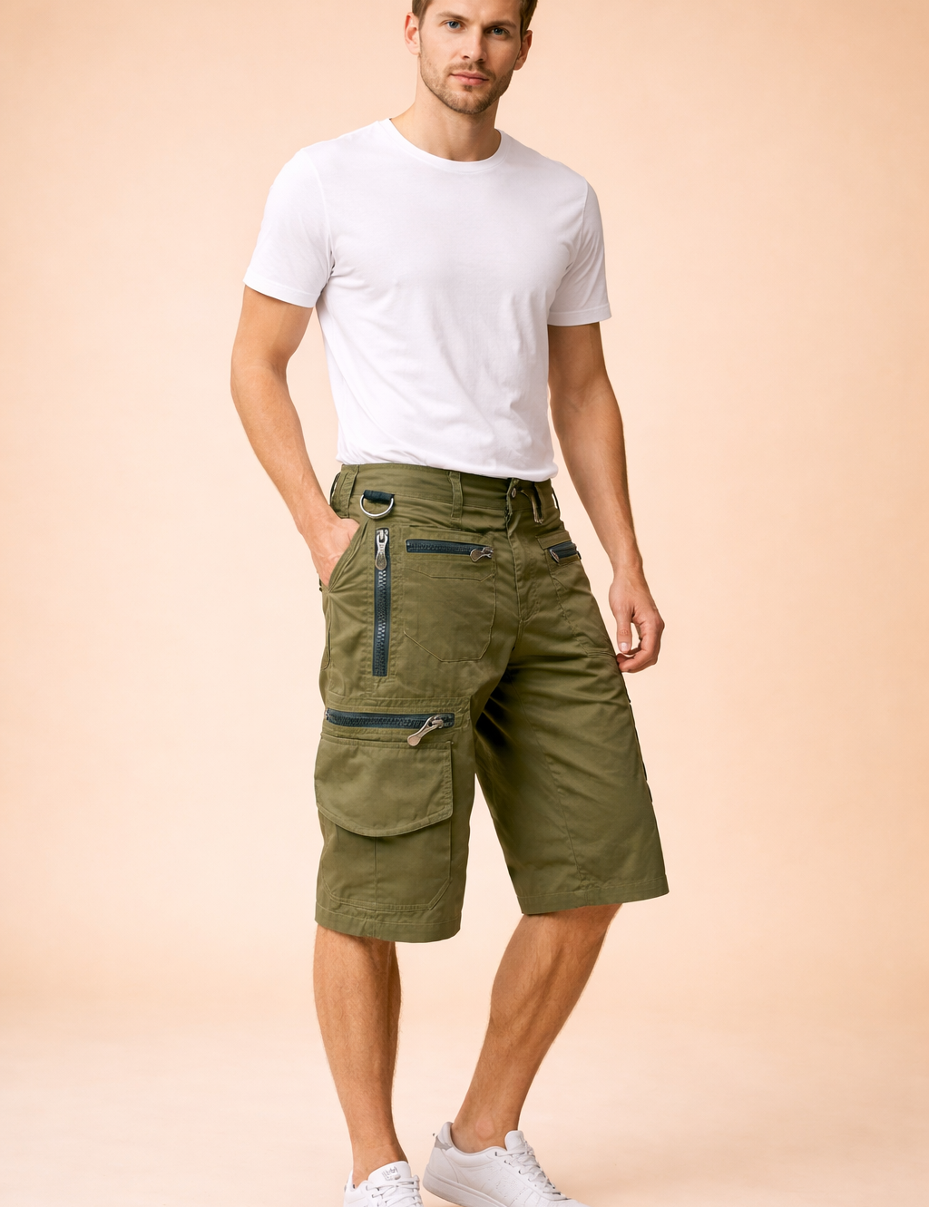 Olive green military-style cargo shorts with a structured cotton-blend fabric, featuring reinforced stitching, multiple utility pockets with metal zippers and flap closures, adjustable waistband detailing, and a straight knee-length cut, paired with a solid royal blue short-sleeve crew-neck T-shirt in smooth jersey cotton and clean white low-top athletic sneakers with layered mesh and rubber soles.