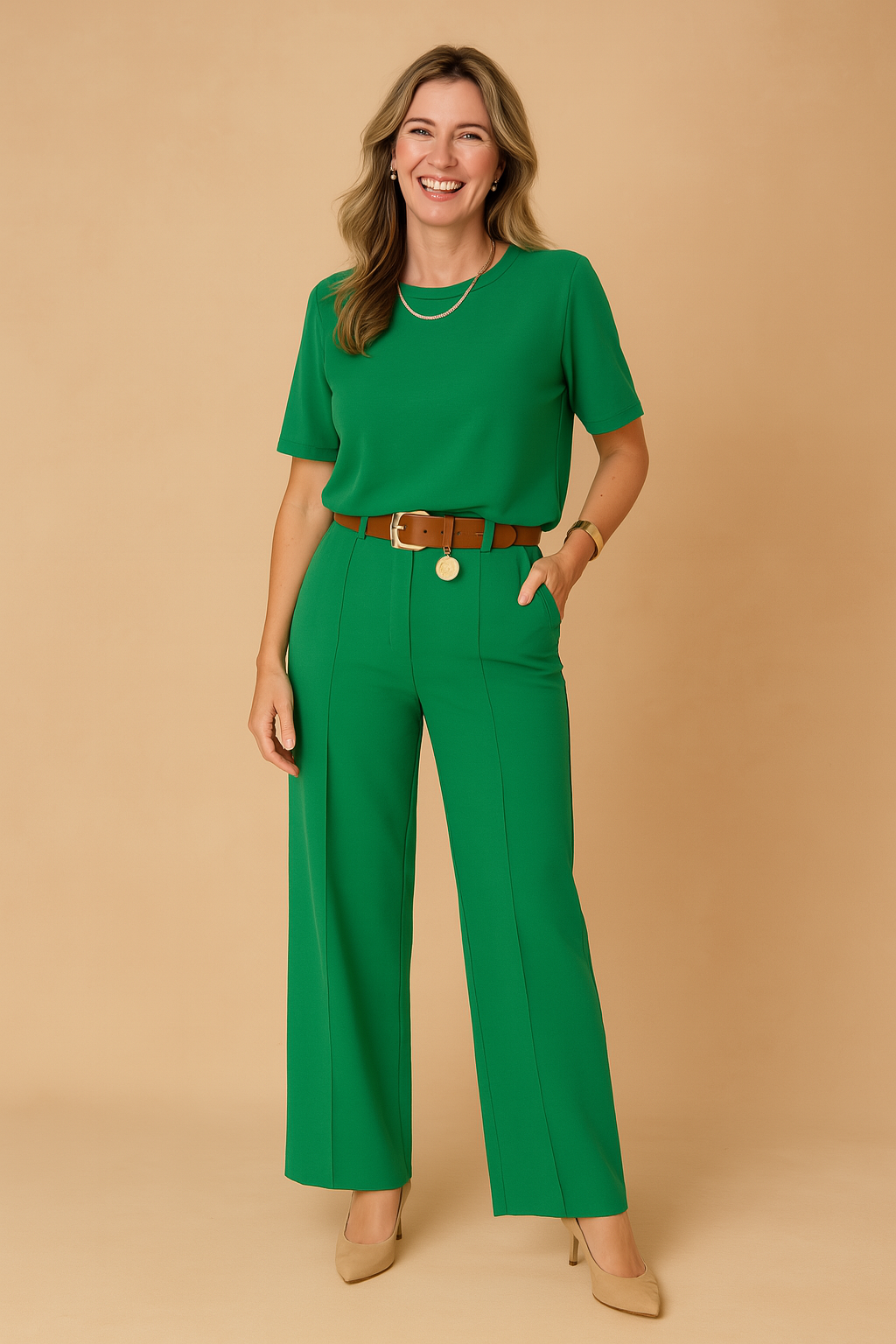 Stylish two-piece green coords set featuring a relaxed-fit short-sleeve top and high-waisted wide-leg trousers, finished with front seams and a statement tan belt with a gold medallion accent.