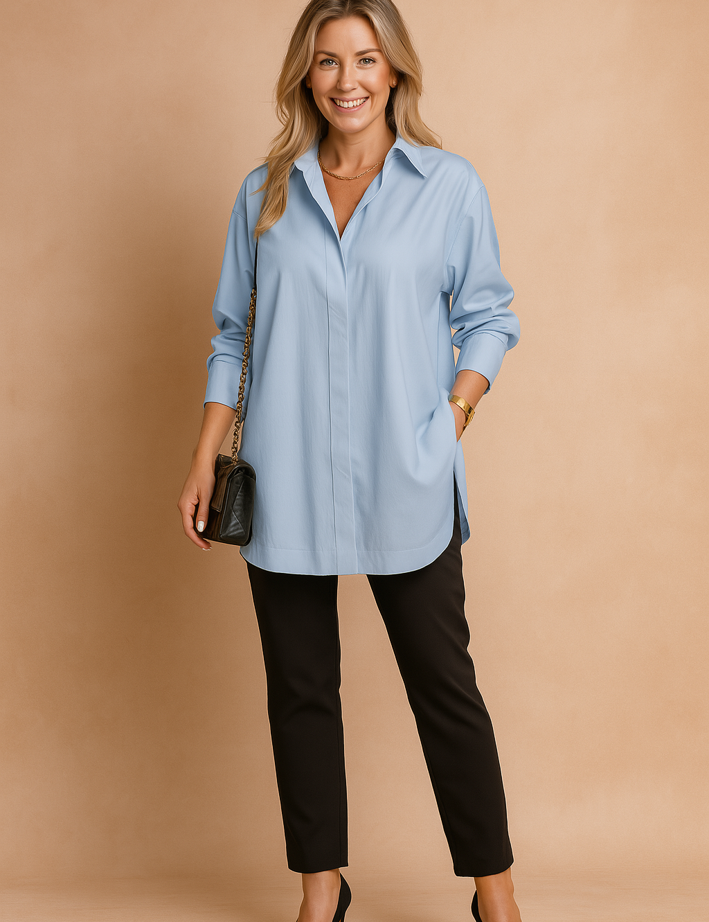 Oversized light blue collared blouse with long sleeves and a clean concealed button placket, styled with slim-fit black trousers and a quilted black chain-strap handbag.