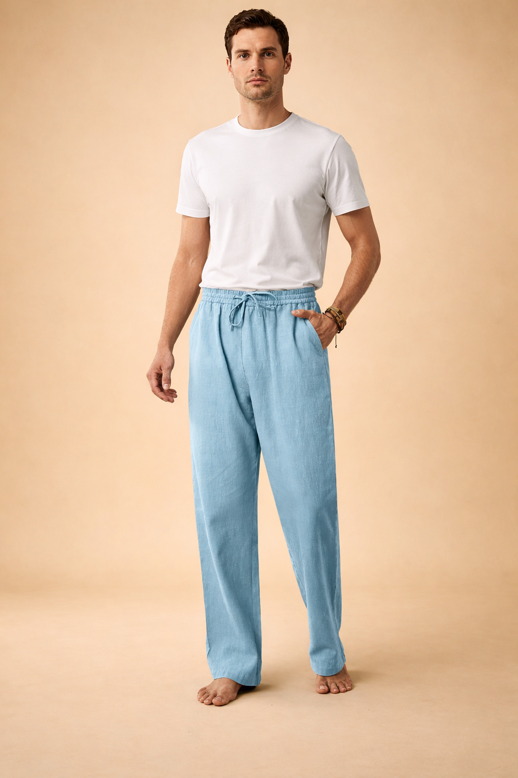 Relaxed men’s drawstring trousers with a straight-leg cut, elasticated waistband, adjustable tie detail, and fluid drape, designed for a clean modern silhouette and everyday wear.