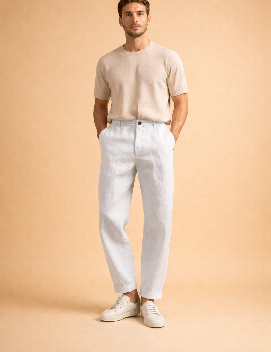 Men’s tailored green trousers with a relaxed straight-leg cut, front pleat detail, cuffed hems, and clean waistband styling, paired with minimalist white low-top sneakers for a refined modern look.