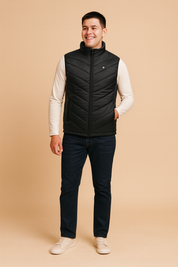 Men's black heated vest with zip closure and subtle chevron quilted design, designed for warmth and outdoor wear