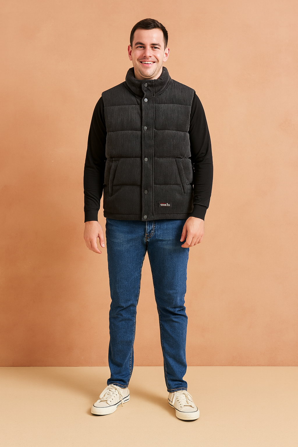 Men’s stylish black padded winter vest with front snap buttons, quilted design, and practical side pockets, perfect for layering in cold weather.