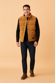 Men’s stylish brown padded winter vest with front snap buttons, quilted design, and practical side pockets, perfect for layering in cold weather.