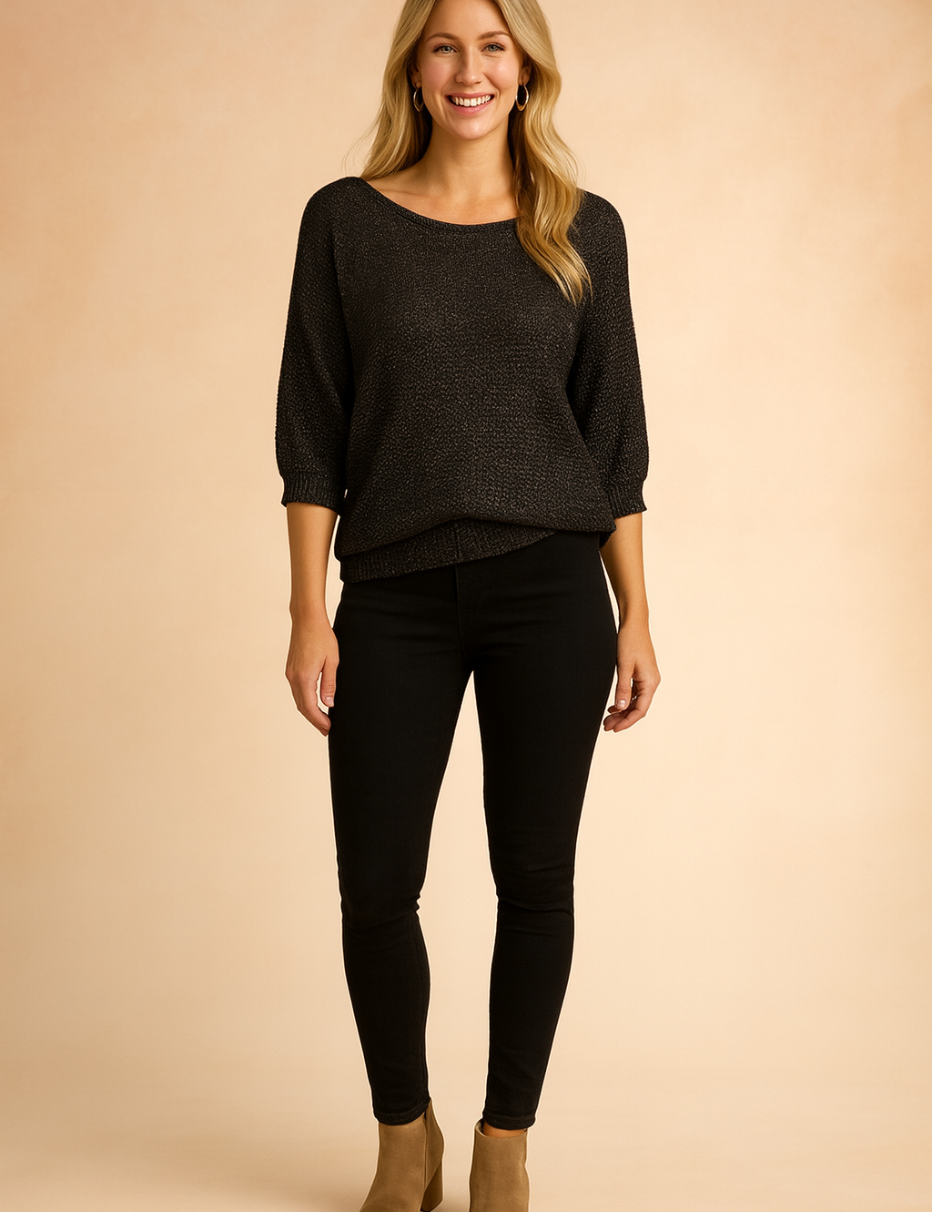 Dark charcoal knit top with elbow-length sleeves, relaxed ribbed hem, and scoop neckline, paired with black skinny pants and tan ankle boots.