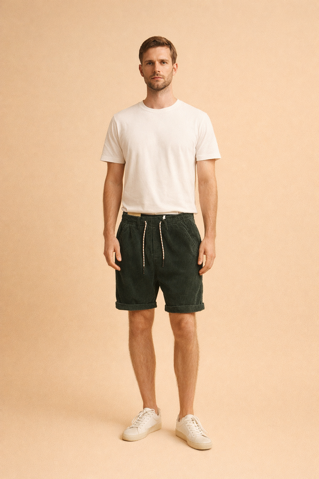 Ribbed corduroy knee-length shorts with elastic waistband and drawstring, styled with a clean minimalist shirt and low-profile casual sneakers for a refined everyday look