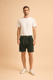 Ribbed corduroy knee-length shorts with elastic waistband and drawstring, styled with a clean minimalist shirt and low-profile casual sneakers for a refined everyday look