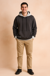Men’s dark grey hoodie with light grey hood lining and drawstrings, featuring a relaxed fit and ribbed cuffs for modern streetwear style.