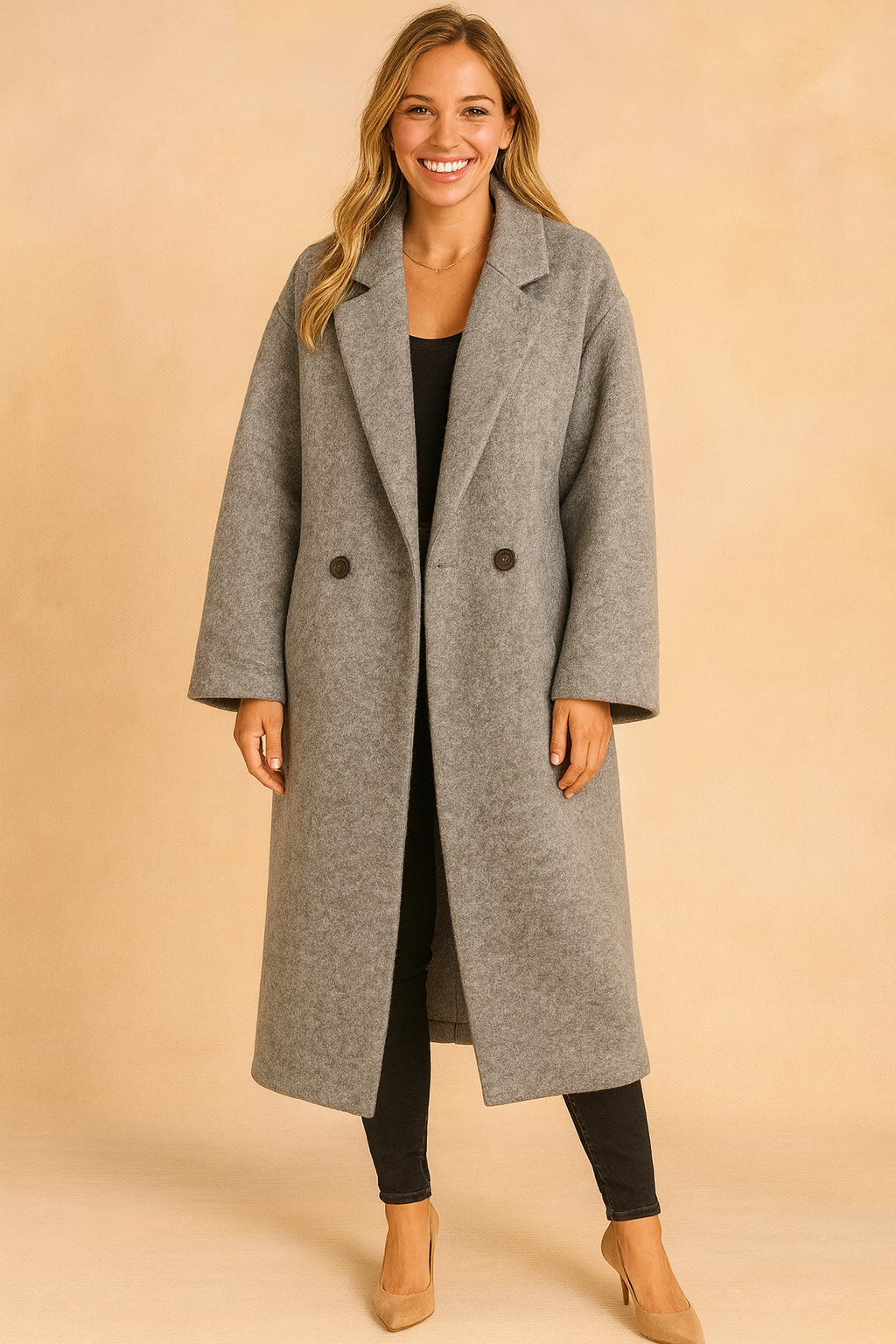 Long gray oversized double-breasted coat with wide lapels, paired with black slim-fit pants and beige heels.