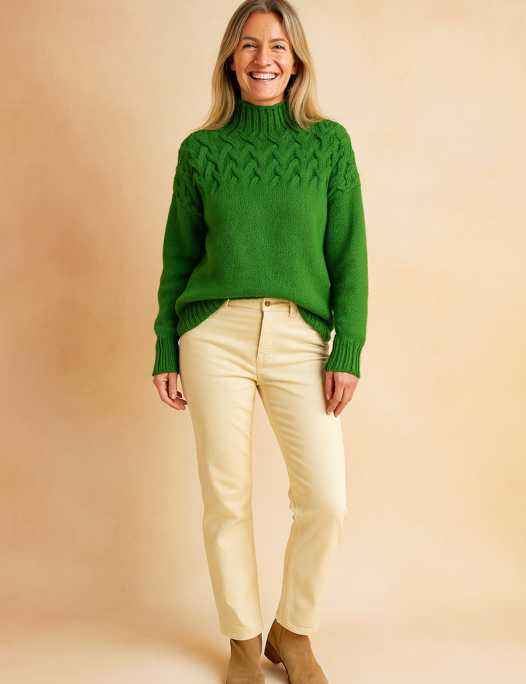 reen cable-knit high-neck sweater paired with cream straight-leg pants and tan suede ankle boots