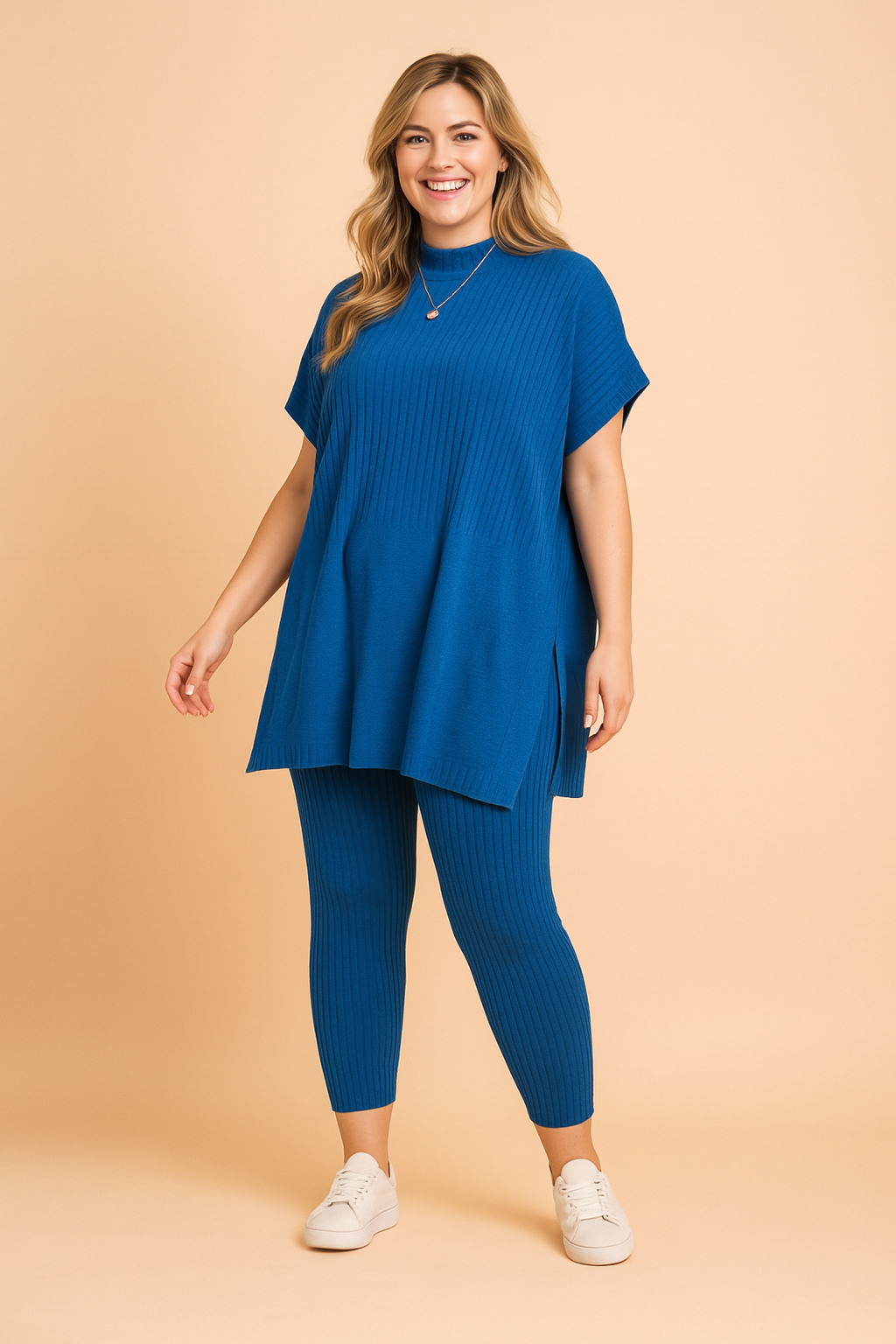 Ribbed knit cobalt blue co-ord set featuring a loose-fitting short-sleeve top with side slits and matching ankle-length fitted leggings, styled with white sneakers.