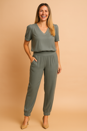 Two-piece coord set featuring a relaxed-fit V-neck blouse and high-waisted jogger pants with elastic cuffs, all in a cool-toned muted sage grey shade. The outfit showcases a smooth, lightweight fabric with soft draping and subtle pleating along the waistband for a polished, versatile look.