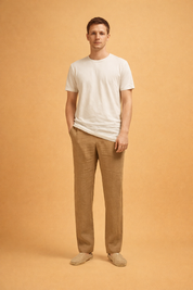 Black straight-leg trousers styled with a clean white short-sleeve top and neutral beige slip-on shoes, featuring a relaxed fit, smooth front, and full-length cut suitable for everyday wear.