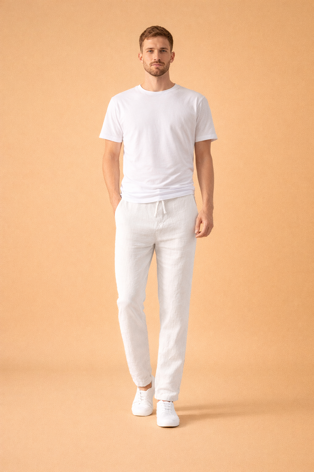 Relaxed slim-fit trousers with an elastic drawstring waist, straight tapered legs, lightweight textured fabric drape, and clean ankle finish, styled with a minimalist short-sleeve top and low-profile lace-up sneakers.
