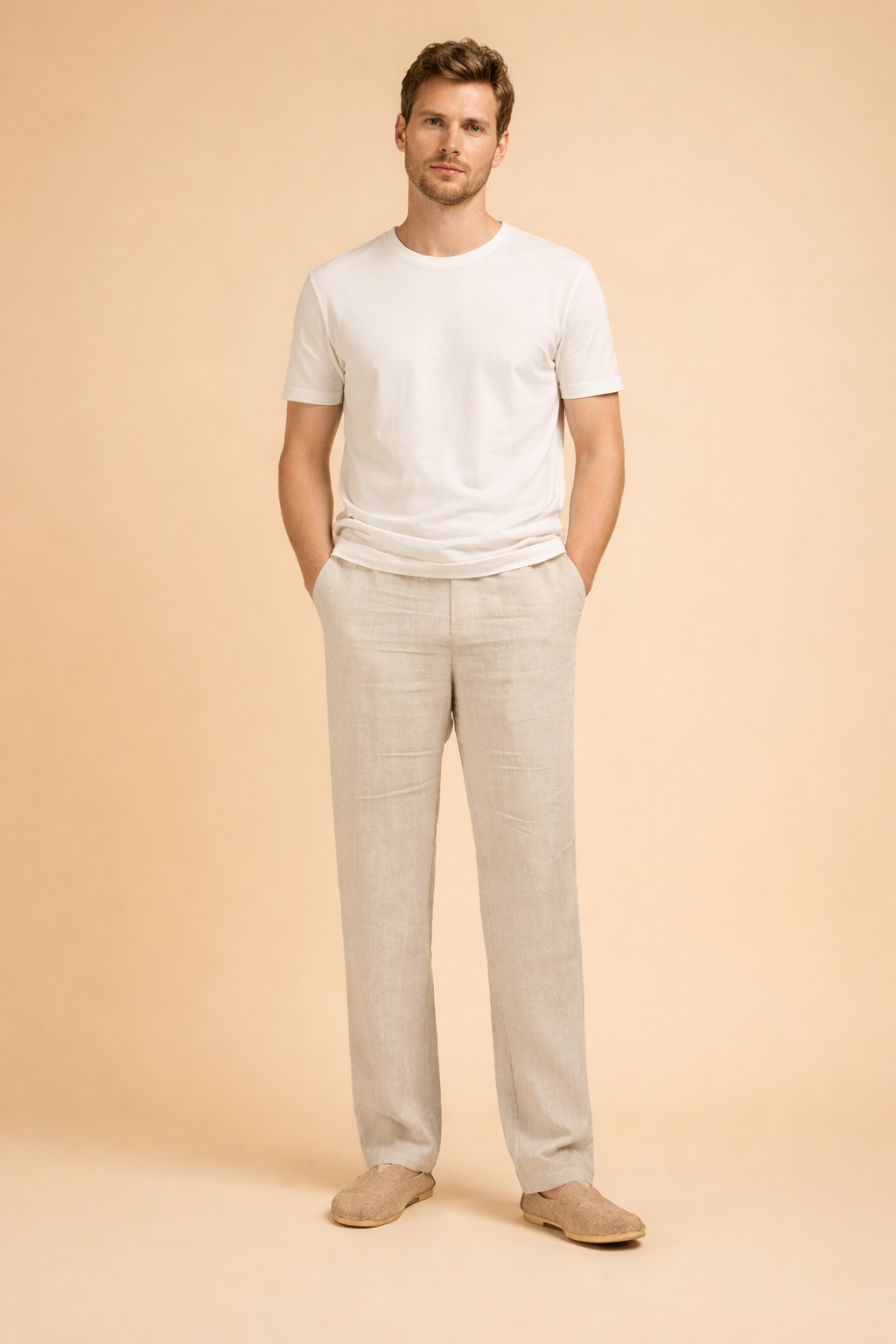 Men’s tailored straight-leg trousers with a relaxed fit, clean front construction, side pockets, and full-length legs styled with minimalist slip-on shoes for a refined everyday look.