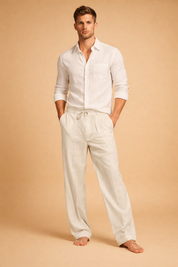 Relaxed-fit tailored trousers with a clean straight-leg silhouette, featuring a drawstring waistband, subtle front pleats, and a smooth drape, paired with a long-sleeve button-up shirt with a classic collar, chest pocket, and neatly rolled cuffs for a refined casual look.