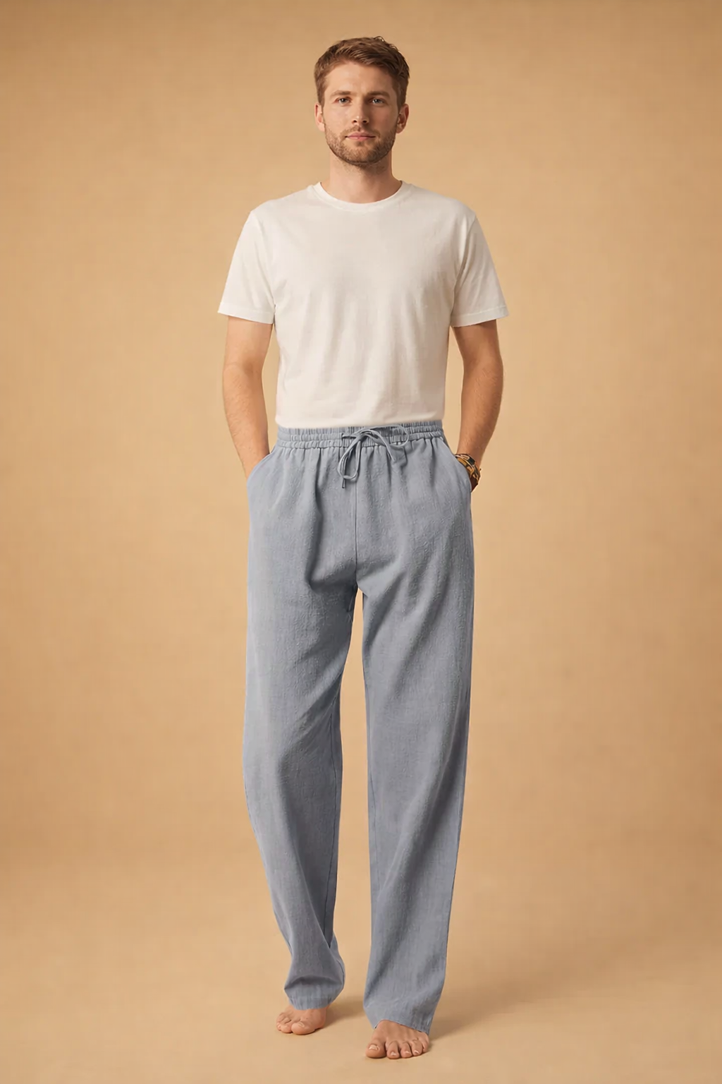 Relaxed-fit drawstring trousers with a straight-leg silhouette paired with a clean long-sleeve button-front shirt, styled in a refined minimalist look suitable for modern casual wear.