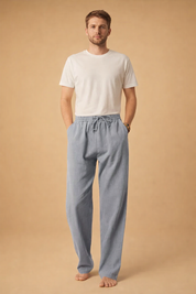 Relaxed-fit drawstring trousers with a straight-leg silhouette paired with a clean long-sleeve button-front shirt, styled in a refined minimalist look suitable for modern casual wear.