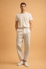 Relaxed-fit men’s tailored trousers with a straight leg silhouette, clean front closure, belt loops, side pockets, and subtle ankle-length finish, styled with minimalist low-profile sneakers for a refined everyday look.