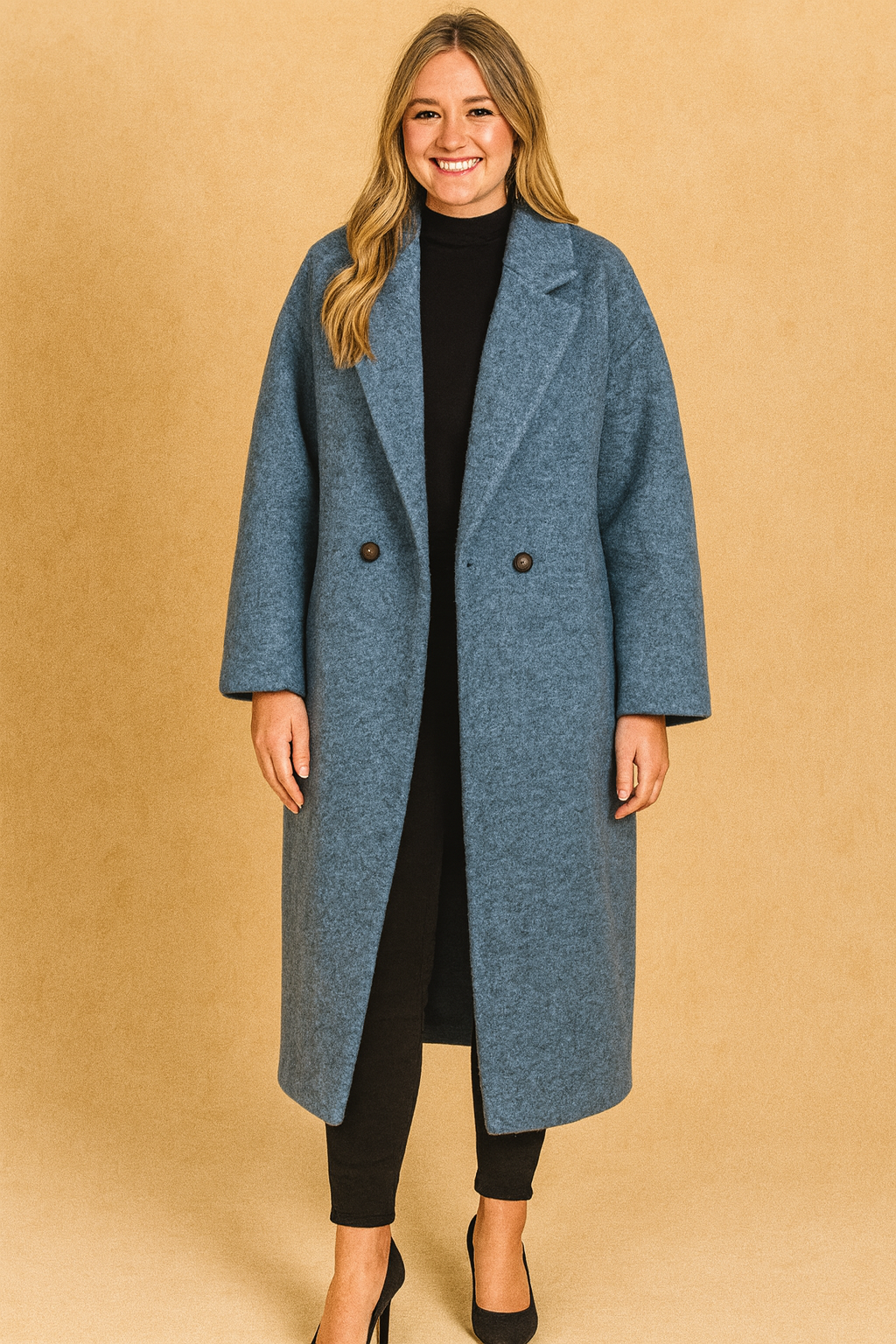 Oversized blue wool coat with button closure, styled with a black turtleneck, slim black trousers, and black pumps.