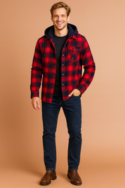 Red and black plaid hooded flannel jacket with button closure, chest pocket detail, slim dark blue jeans, and brown leather Chelsea boots.