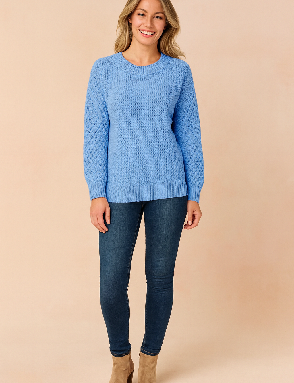 Sky blue textured knit sweater with patterned sleeves, paired with dark blue skinny jeans and taupe suede ankle boots.