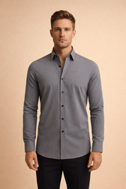 Slim-fit long-sleeve button-down shirt with a structured collar, smooth tailored silhouette, clean front placket, and refined cuffs designed for a modern, polished look.
