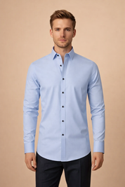Slim-fit long-sleeve button-down shirt with a clean spread collar, smooth woven texture, tailored silhouette, and contrasting dark buttons for a refined formal look.