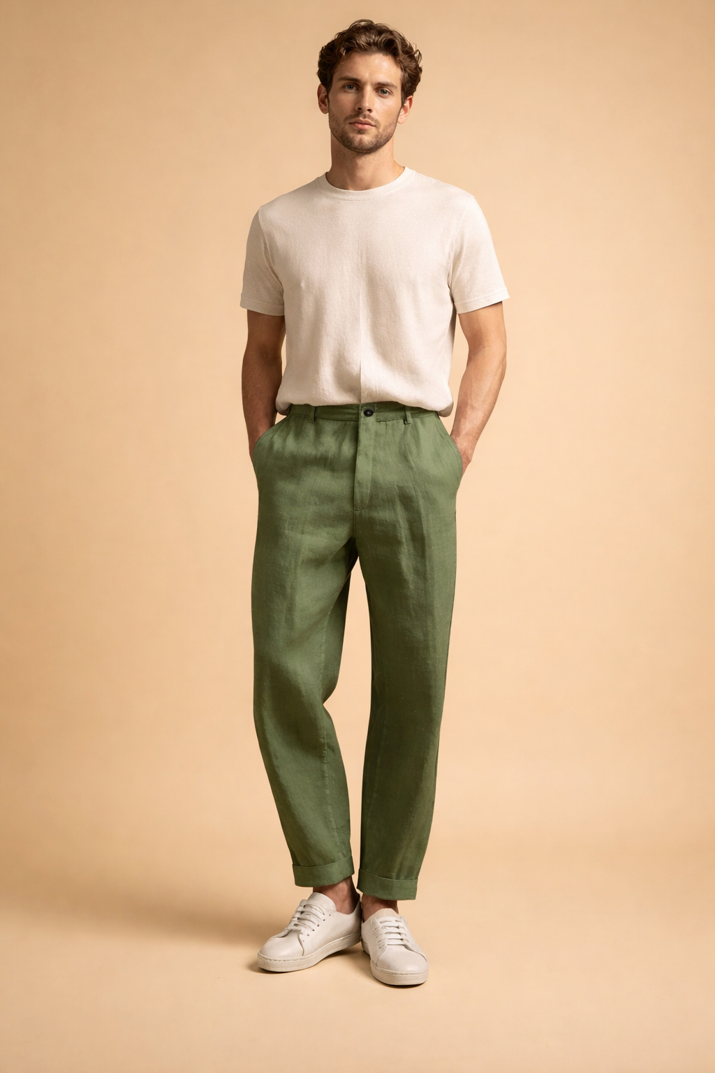 Tailored slim-fit men’s trousers with a clean front, straight tapered legs, ankle-length finish, smooth structured drape, discreet waistband closure, and minimal detailing, styled with low-profile sneakers for a modern refined look.