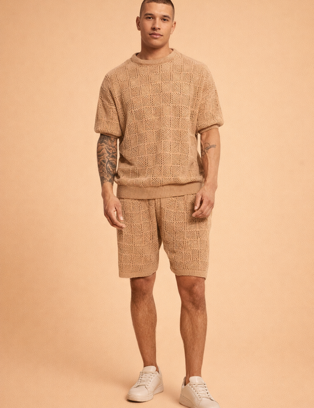 Men’s coordinated tan knit short-sleeve sweater and matching shorts set featuring a breathable geometric open-weave pattern, ribbed crew neckline, ribbed hem finish, relaxed tailored fit, and clean white low-profile sneakers for a refined summer casual look
