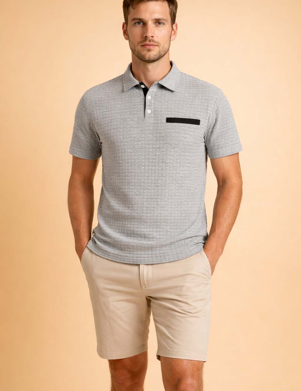 Textured short-sleeve polo top with structured collar and button placket, paired with tailored knee-length chino shorts for a clean modern men’s outfit.