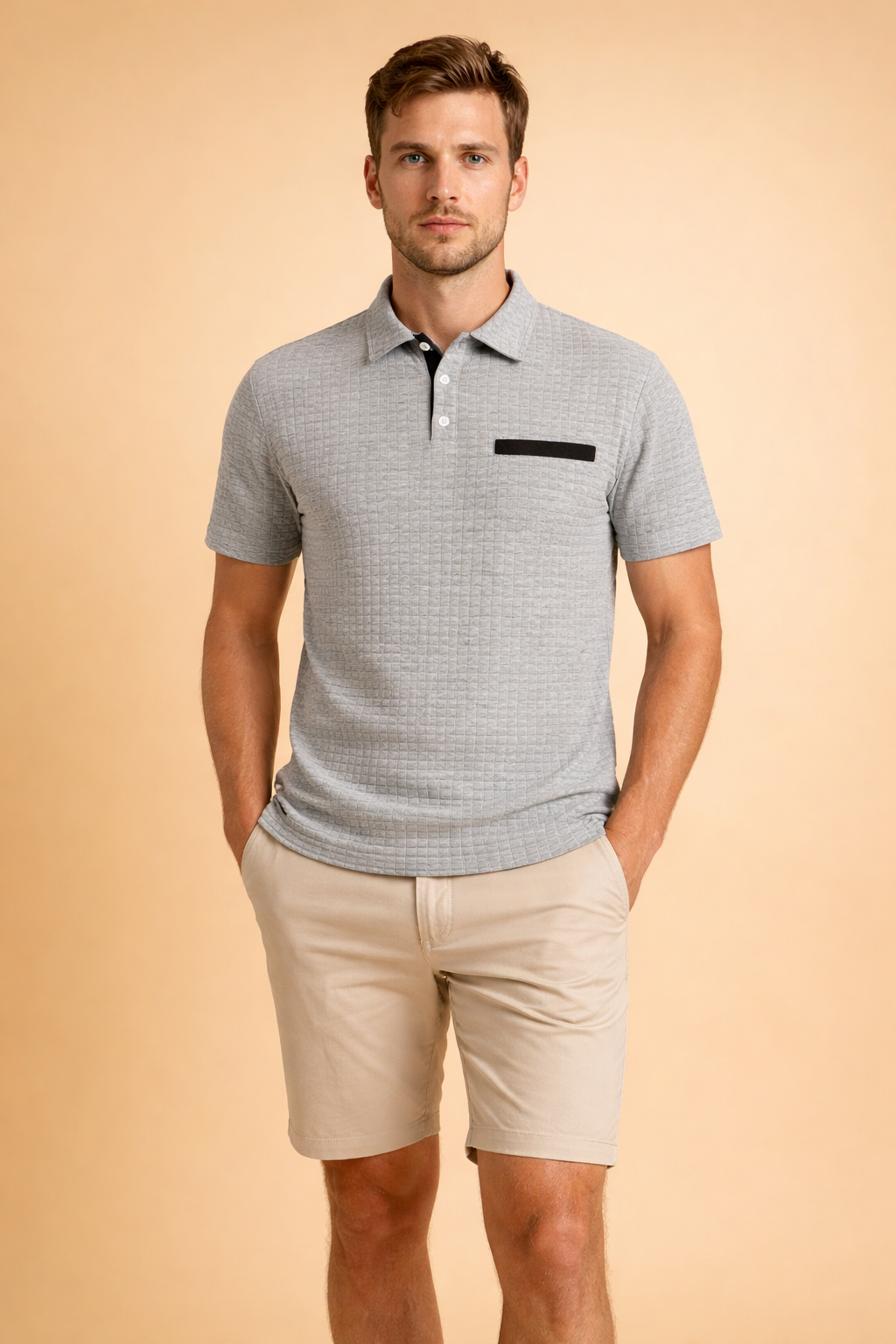 Textured short-sleeve polo top with structured collar and button placket, paired with tailored knee-length chino shorts for a clean modern men’s outfit.
