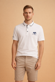 White short-sleeve polo shirt with structured collar, button placket, fine textured fabric, and embroidered crest logo on chest and sleeve