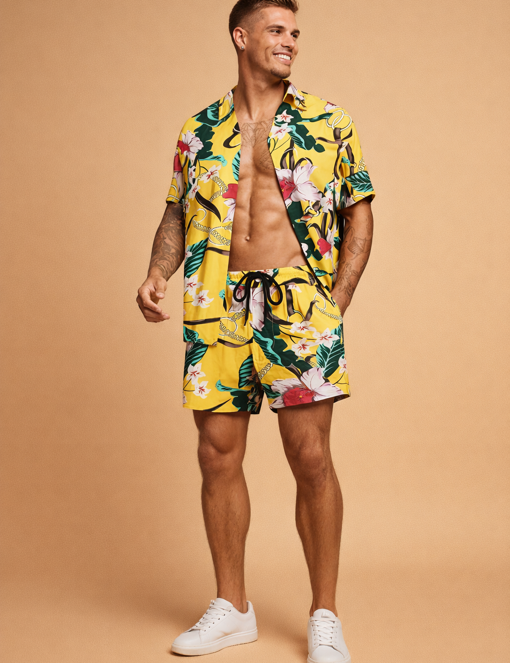 Yellow tropical print short-sleeve button-up shirt with matching drawstring shorts featuring bold floral and leaf motifs in green, white, pink, and black, styled as a coordinated summer set with a relaxed tailored fit and lightweight fabric drape, paired with clean minimalist footwear for a polished resort look